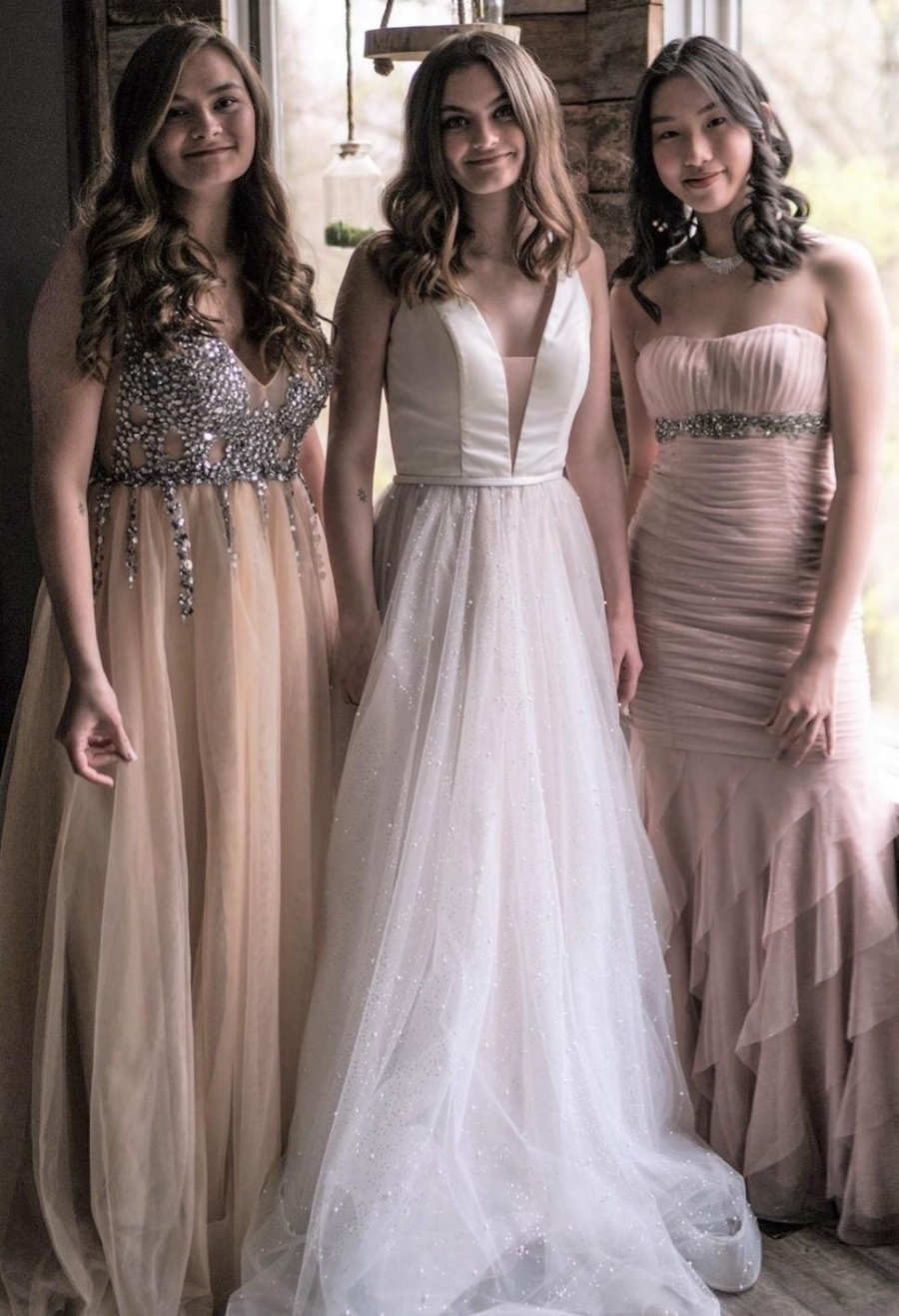 girls wearing prom dresses